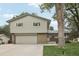 Classic two-story home featuring a brick-accented facade, attached garage, and established front yard at 6514 Zinnia St, Arvada, CO 80004