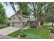 Well-maintained home with beautiful landscaping, a long driveway, and attached garage at 6514 Zinnia St, Arvada, CO 80004