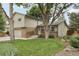 Charming home with lush front lawn, mature trees, and a paved walkway to the entrance at 6514 Zinnia St, Arvada, CO 80004