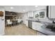 Bright open kitchen featuring stainless steel appliances, white cabinets and access to other living spaces at 6514 Zinnia St, Arvada, CO 80004
