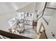 Open-concept living room with staircase, and kitchen beyond at 6514 Zinnia St, Arvada, CO 80004