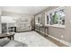 Cozy living room with neutral walls, wood floors, stylish furniture, and bright windows at 6514 Zinnia St, Arvada, CO 80004