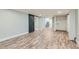 Spacious basement featuring light wood flooring, sliding barn door, and a laundry area at 101 S 11 Ave, Brighton, CO 80601