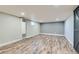 Finished basement with hardwood flooring and modern-style radiator at 101 S 11 Ave, Brighton, CO 80601