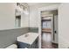 Cozy bathroom featuring grey backsplash, matching vanity, and tile flooring at 101 S 11 Ave, Brighton, CO 80601
