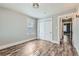 A well-lit bedroom features a closet with sliding doors and matching light wood flooring at 101 S 11 Ave, Brighton, CO 80601