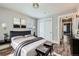 Bedroom with neutral walls, plush bed with gray accents, and wood-look floors at 101 S 11 Ave, Brighton, CO 80601
