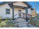 Inviting front porch with wood railing, steps and cute landscaping at 101 S 11 Ave, Brighton, CO 80601