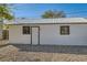 Exterior view of a white garage or outbuilding with a metal roof and gravel ground at 101 S 11 Ave, Brighton, CO 80601