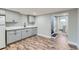 Kitchenette area with grey cabinets, white countertops, and wood-look flooring at 101 S 11 Ave, Brighton, CO 80601