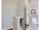 Laundry room with white walls, storage niche, and a glimpse of the exterior through the door at 101 S 11 Ave, Brighton, CO 80601