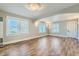 Open living area with wood floors, neutral walls, and natural light from the windows at 101 S 11 Ave, Brighton, CO 80601