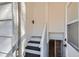 Interior staircase with painted stairs and banister leading to the upper level at 101 S 11 Ave, Brighton, CO 80601