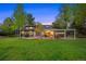 Wide view of the backyard highlighting the manicured lawn, patio, and pergola at 5735 Big Canon Dr, Greenwood Village, CO 80111