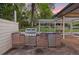 Outdoor kitchen with stainless steel grill and pergola covered patio at 5735 Big Canon Dr, Greenwood Village, CO 80111
