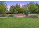 Expansive backyard featuring a patio area and lush green lawn at 5735 Big Canon Dr, Greenwood Village, CO 80111