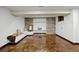 Finished basement with a stone accent wall, built in shelving, window, and stained concrete floors at 5735 Big Canon Dr, Greenwood Village, CO 80111