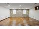 Finished basement with stained concrete floors, white walls, and a stone accent wall at 5735 Big Canon Dr, Greenwood Village, CO 80111