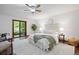Bright bedroom featuring a ceiling fan, hardwood floors and a sliding glass door to the backyard at 5735 Big Canon Dr, Greenwood Village, CO 80111