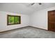 Bright, carpeted bedroom featuring a large window with views at 5735 Big Canon Dr, Greenwood Village, CO 80111