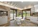 Bright dining area with stone accents, a tiled floor, and sliding glass doors at 5735 Big Canon Dr, Greenwood Village, CO 80111