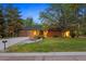 Charming brick home featuring a well-manicured lawn, mature trees, and a two-car garage at 5735 Big Canon Dr, Greenwood Village, CO 80111