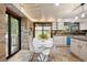 Bright eat-in kitchen features a modern design, white cabinets and a sliding door to the backyard at 5735 Big Canon Dr, Greenwood Village, CO 80111