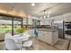 Bright open kitchen features a center island, stainless steel appliances, and backyard views at 5735 Big Canon Dr, Greenwood Village, CO 80111