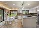 Bright kitchen features a center island, stainless steel appliances, and sliding door to backyard at 5735 Big Canon Dr, Greenwood Village, CO 80111