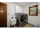 Convenient laundry room with modern washer, dryer, sink, and storage cabinets at 5735 Big Canon Dr, Greenwood Village, CO 80111