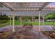 Inviting outdoor patio with a pergola, stone pavers, and a picnic table at 5735 Big Canon Dr, Greenwood Village, CO 80111