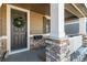 Inviting front porch with stone pillars and a dark brown door at 5135 Ditmars Trl, Castle Rock, CO 80104