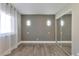 Bright bedroom with mirrored closet and wood-look floors at 9195 E Lehigh Ave # 151, Denver, CO 80237