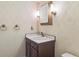 Charming bathroom with patterned wallpaper, ornate mirror, and classic fixtures at 372 Vance St, Lakewood, CO 80226