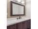 Bathroom with wood vanity, framed mirror, and solid surface countertop at 372 Vance St, Lakewood, CO 80226