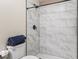Bathroom featuring a new shower with marble-look tile and matte black fixtures at 372 Vance St, Lakewood, CO 80226
