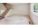 Bright living room features a staircase, large window, and neutral carpeting at 372 Vance St, Lakewood, CO 80226