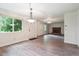 Open-concept living room with a brick fireplace, wood-style flooring, and ample natural light at 372 Vance St, Lakewood, CO 80226
