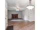 Cozy living room features a brick fireplace, modern light fixture, and neutral walls at 372 Vance St, Lakewood, CO 80226