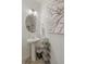 Simple bathroom with pedestal sink, round mirror, and decorative art at 3319 Belleville Ridge Rd, Elizabeth, CO 80107