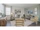 Living room with gray sofa and two armchairs at 3319 Belleville Ridge Rd, Elizabeth, CO 80107