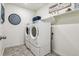 Convenient laundry room with washer, dryer, and shelving at 4607 Cattle Cross Trl, Castle Rock, CO 80104