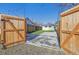 Backyard with wooden gate and grassy area at 5535 Brentwood St, Arvada, CO 80002