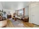 Bright and airy living room with hardwood floors, stylish furniture, and large windows at 5535 Brentwood St, Arvada, CO 80002