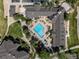 Overhead aerial view of a pool with lounge chairs and community building at 12914 Ironstone Way # 102, Parker, CO 80134