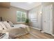 Comfortable bedroom with a large window, neutral decor, and modern lighting at 12914 Ironstone Way # 102, Parker, CO 80134