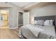 Well-lit bedroom with hardwood floors, a queen-size bed, and a glimpse of the bathroom at 12914 Ironstone Way # 102, Parker, CO 80134