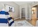 Bright bedroom featuring neutral walls, closet, bathroom, accent rug, and a play teepee tent at 12914 Ironstone Way # 102, Parker, CO 80134