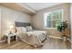 Cozy bedroom with a queen-size bed, large window, and stylish decor at 12914 Ironstone Way # 102, Parker, CO 80134