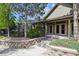 Close up of the entrance to a clubhouse surrounded by foliage and rock retaining walls at 12914 Ironstone Way # 102, Parker, CO 80134